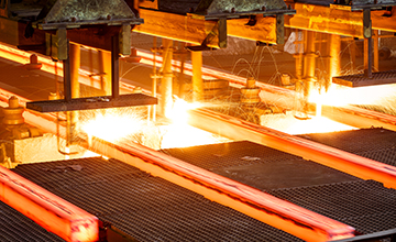 hot steel on conveyor Close shot in steel mill